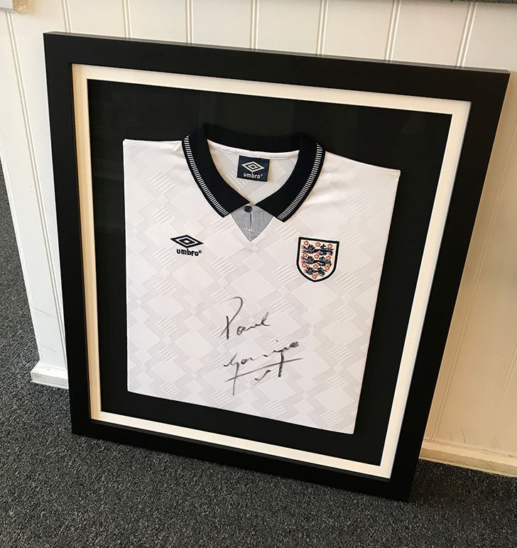 Signed white England shirt in a black frame