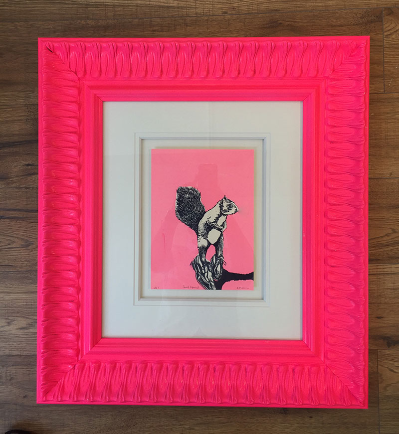 Silk screen print of a squirrel in a neon pink frame