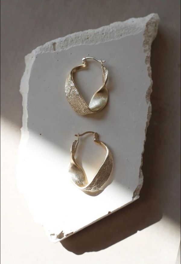 a pair of twisted hoop earrings