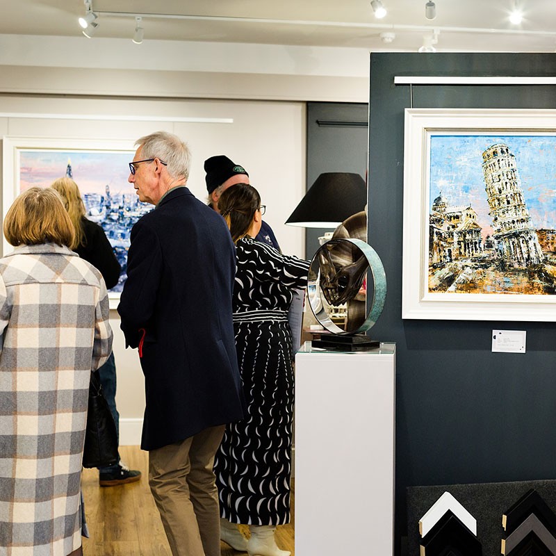 A group of people viewing painting in the gallery