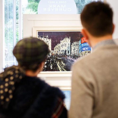 2 people viewing a painting in the window